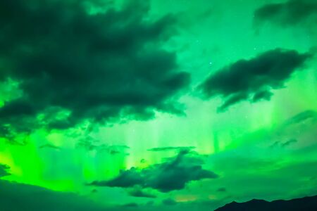 Aurora borealis in the night northern sky. Ionization of air particles in the upper atmosphere.の写真素材