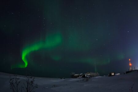 Aurora borealis in the night northern sky. Ionization of air particles in the upper atmosphere.の写真素材