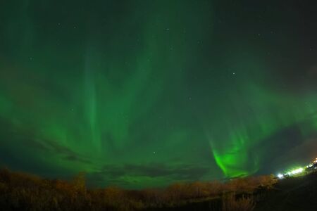 Aurora borealis in the night northern sky. Ionization of air particles in the upper atmosphere.の写真素材