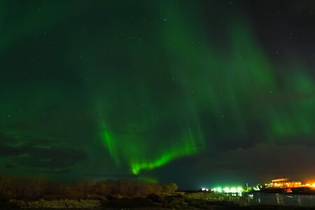 Aurora borealis in the night northern sky. Ionization of air particles in the upper atmosphere.