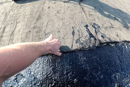 Roofing from roofing felts and resin. Sealing roofing material on the roof.の写真素材