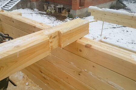 Sawing a groove in a bar. Collecting a house from a log house.の写真素材