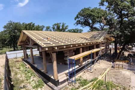 Stage of construction of a wooden house. Constructed from a wooden log house, wooden house.の写真素材