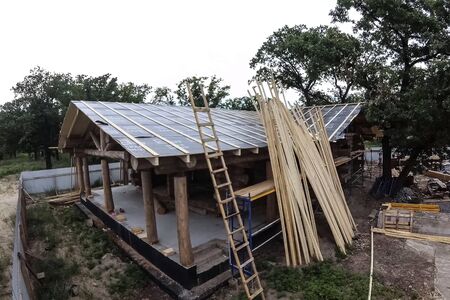 Stage of construction of a wooden house. Constructed from a wooden log house, wooden house.の写真素材