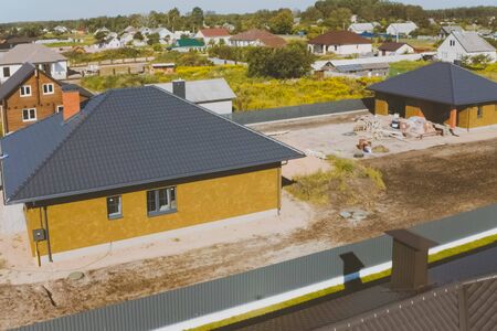 A new house, the roof of which is made of metal. Cottage in the countryside. roof made of modern materials.の写真素材