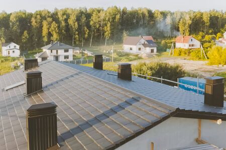 Modern roof made of metal. dark gray roof of an industrial building made of metal. Corrugated metal...