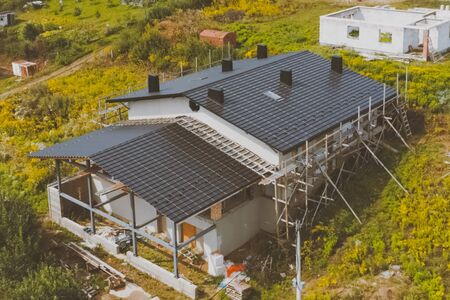 Modern roof made of metal. dark gray roof of an industrial building made of metal. Corrugated metal roof and metal roofing.の写真素材