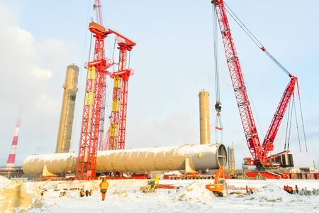 Tobolsk, Russia - June 14, 2018: Construction of a petrochemical and oil refinery near the city of Tobolsk in Russia, workers working on the installation and construction of the plant.の写真素材