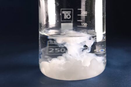Chemical experiments with chemicals, flasks and mixing chemicals.