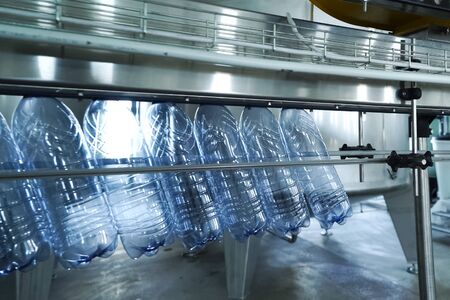 Filling line of sparkling water in a pet bottle. Mini factory for bottling water.の写真素材