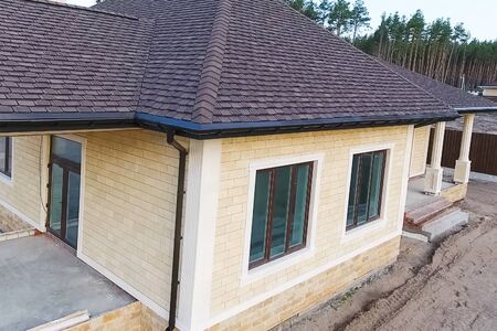 House with a roof from a bituminous tile. Bituminous tile for a roof. a roof from a bituminous tile.の写真素材