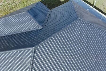House with a gray metal roof. Modern roof made of metal. Corrugated metal roof and metal roofing.の写真素材