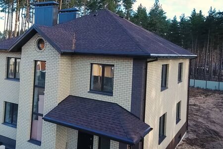 House with a roof from a bituminous tile. Bituminous tile for a roof. a roof from a bituminous tile.の写真素材