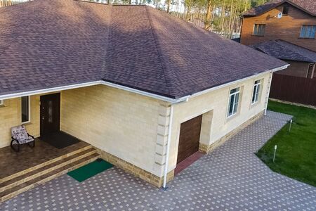 House with a roof from a bituminous tile. Bituminous tile for a roof. a roof from a bituminous tile.の写真素材