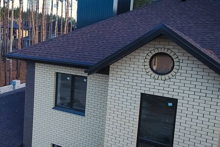House with a roof from a bituminous tile. Bituminous tile for a roof. a roof from a bituminous tile.の写真素材
