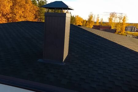 House with a roof from a bituminous tile. Bituminous tile for a roof. a roof from a bituminous tile.の写真素材