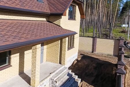 House with a roof from a bituminous tile. Bituminous tile for a roof. a roof from a bituminous tile.の写真素材