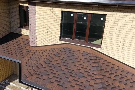 House with a roof from a bituminous tile. Bituminous tile for a roof. a roof from a bituminous tile.の写真素材