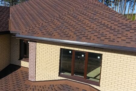 House with a roof from a bituminous tile. Bituminous tile for a roof. a roof from a bituminous tile.の写真素材