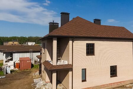 House with a roof from a bituminous tile. Bituminous tile for a roof. a roof from a bituminous tile.の写真素材
