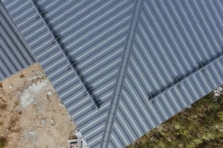 Modern roof made of metal. Corrugated metal roof and metal roofing.
