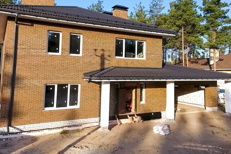 New brick house. House with a ceramic tile roof. cement-sand roof tiles.の写真素材