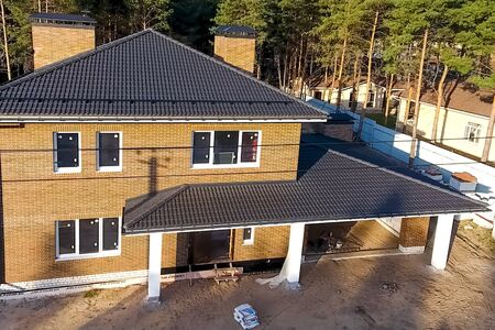 New brick house. House with a ceramic tile roof. cement-sand roof tiles.の写真素材