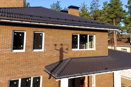 New brick house. House with a ceramic tile roof. cement-sand roof tiles.の写真素材