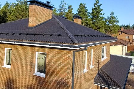 New brick house. House with a ceramic tile roof. cement-sand roof tiles.の写真素材