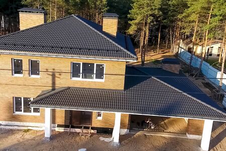 New brick house. House with a ceramic tile roof. cement-sand roof tiles.の写真素材