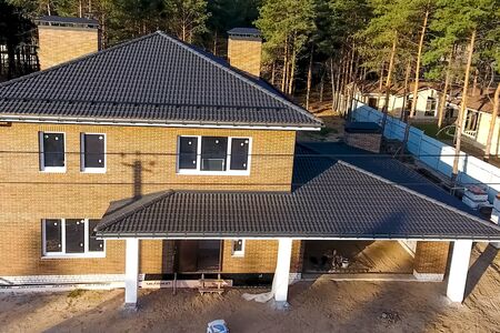 New brick house. House with a ceramic tile roof. cement-sand roof tiles.の写真素材