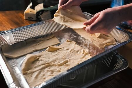 Uncooked puff pastry in an aluminum tray. Uncooked puff pastry in an aluminum tray.の写真素材