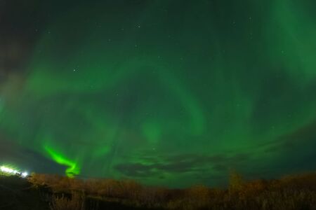 Aurora borealis in the night northern sky. Ionization of air particles in the upper atmosphere.の写真素材