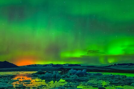 Aurora borealis in the night northern sky. Ionization of air particles in the upper atmosphere.の写真素材