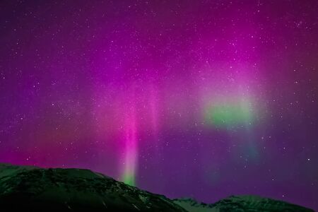 Aurora borealis in the night northern sky. Ionization of air particles in the upper atmosphere.の写真素材