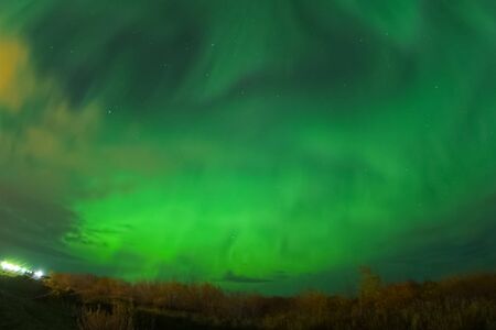 Aurora borealis in the night northern sky. Ionization of air particles in the upper atmosphere.の写真素材
