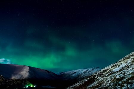 Aurora borealis in the night northern sky. Ionization of air particles in the upper atmosphere.の写真素材
