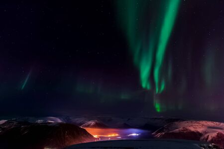 Aurora borealis in the night northern sky. Ionization of air particles in the upper atmosphere.の写真素材