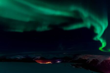 Aurora borealis in the night northern sky. Ionization of air particles in the upper atmosphere.の写真素材