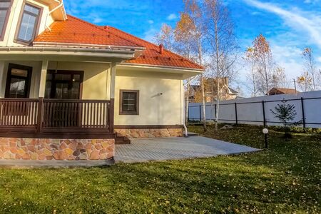 New house with a plot planted with birch trees. Beautiful home ownershipの写真素材