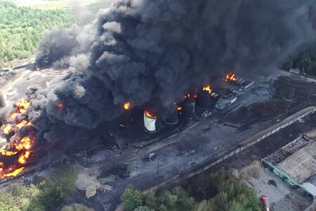 Oil storage fire. The tank farm is burning, black smoke is the combustion of hydrocarbons.の写真素材