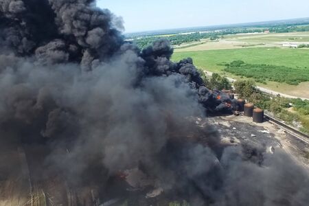Oil storage fire. The tank farm is burning, black smoke is the combustion of hydrocarbons.の写真素材