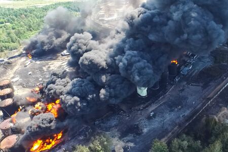 Oil storage fire. The tank farm is burning, black smoke is the combustion of hydrocarbons.の写真素材