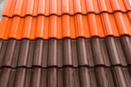 Samples of ceramic roofing tiles in a warehouse of a roofing materials store. Modern roof made of metal. cement sand tiles.の写真素材