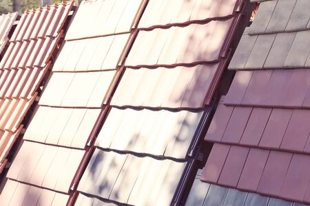 Samples of ceramic roofing tiles in a warehouse of a roofing materials store. Modern roof made of metal. cement sand tiles.の写真素材