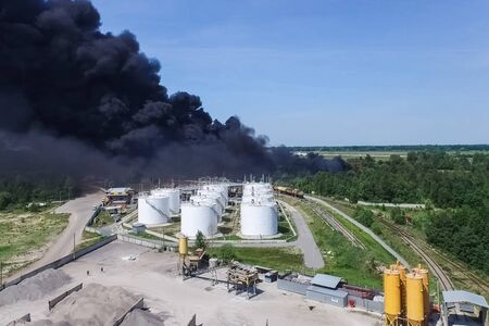 Oil storage fire. The tank farm is burning, black smoke is the combustion of hydrocarbons.の写真素材