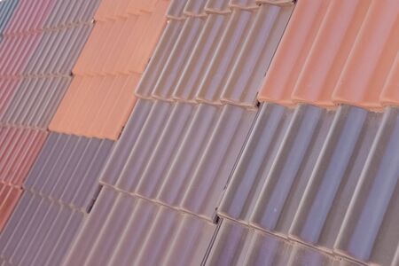 Samples of ceramic roofing tiles in a warehouse of a roofing materials store. Modern roof made of metal. cement sand tiles.の写真素材