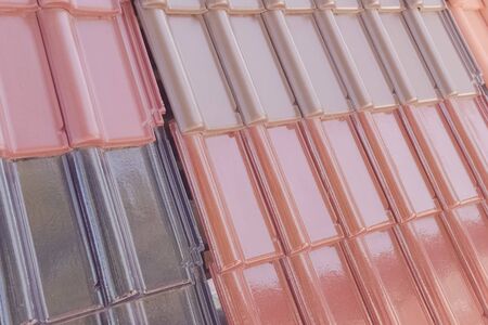 Samples of ceramic roofing tiles in a warehouse of a roofing materials store. Modern roof made of metal. cement sand tiles.の写真素材
