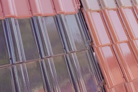 Samples of ceramic roofing tiles in a warehouse of a roofing materials store. Modern roof made of metal. cement sand tiles.の写真素材