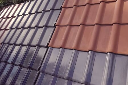 Samples of ceramic roofing tiles in a warehouse of a roofing materials store. Modern roof made of metal. cement sand tiles.の写真素材